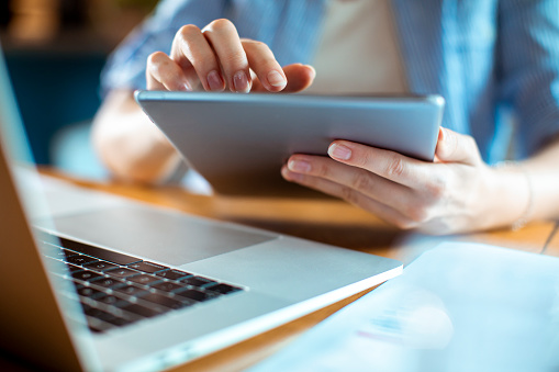 Close up of a woman using a digital tablet at home