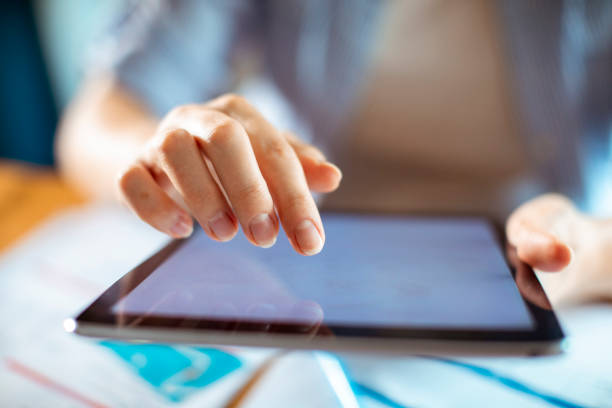 istock Woman using her tablet to pay her home bills 1405107685