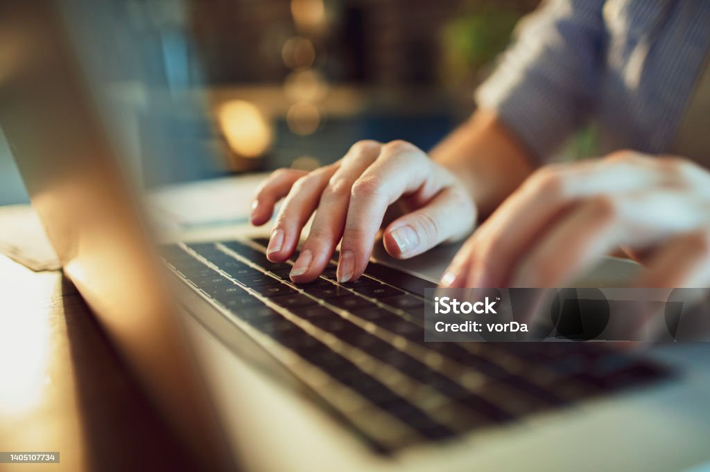 Woman using a Laptop at home Close up of a woman using a laptop at home Computer Keyboard Stock Photo