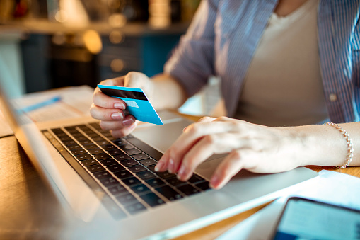 Close up of a woman using her credit card for an online purchase