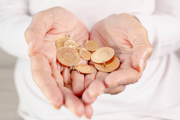 istock Hand holding Turkish gold coin, Close up 1405107910