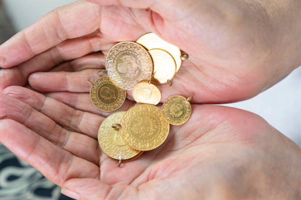 istock Hand holding Turkish gold coin, Close up 1405107918