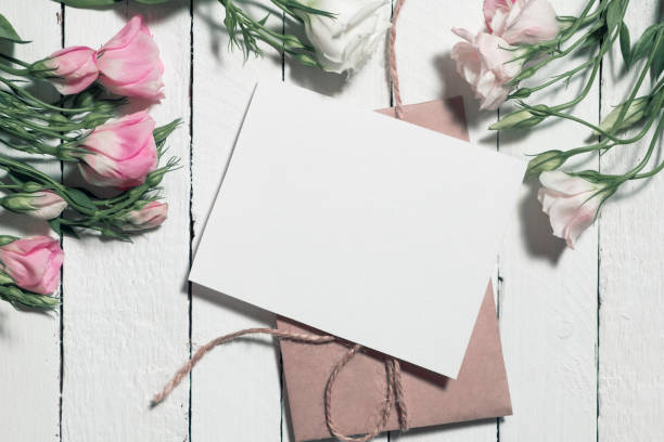 istock Flowers and envelope on white wooden background 1405112990