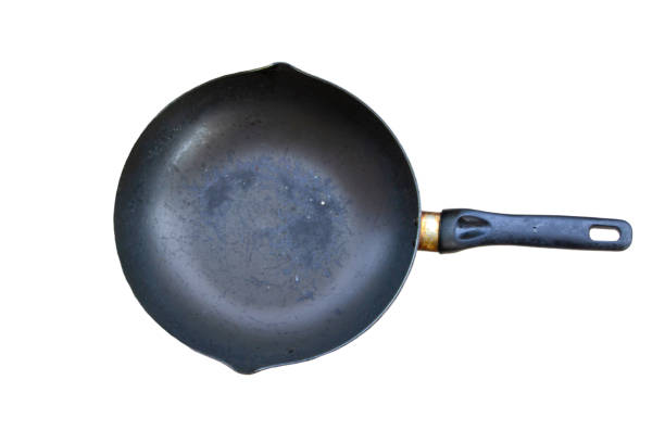 istock old black pan There are yellow stains on the handle. isolated on a white background 1405116266