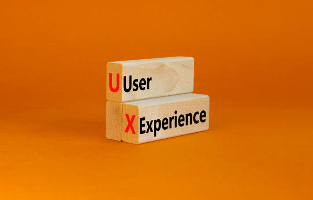 istock UX user experience symbol. Concept words UX user experience on wooden blocks on beautiful orange table orange background, copy space. Business and UX user experience concept. 1405123686