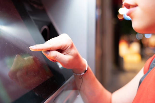 istock woman withdraws money from an ATM 1405125680