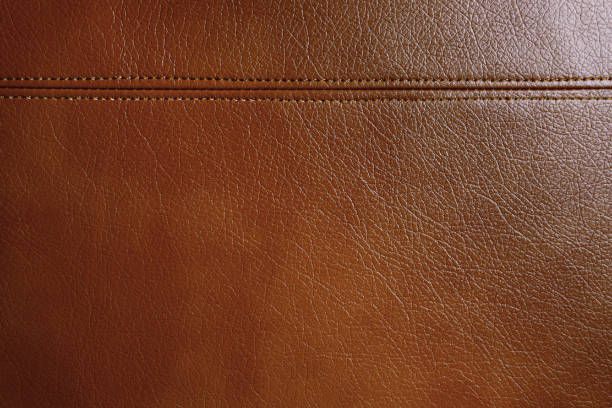 istock Brown leather, leatherette texture background wtih decorative stich 1405128386