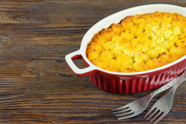 istock Shepherd's Pie or Cottage Pie, traditional British dish on brown wooden backgfound 1405128415