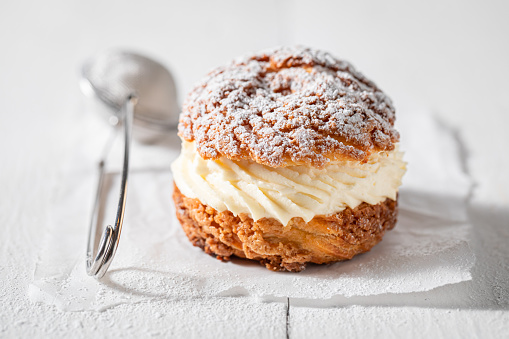Sweet and yummy cream puffs with sugar and vanilla cream. Cream puffs as the perfect dessert.