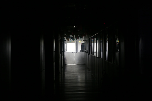 salvador, bahia, brazil - june 24, 2022: corridor of a commercial building with lights off due to a power outage in Salvador.