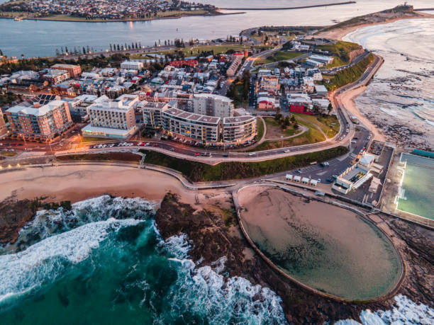 Ariel View Of Newcastle's Ocean Baths and City Back Drop At Sunrise Ocean baths in Newcastle, NSW, Australia newcastle australia stock pictures, royalty-free photos & images