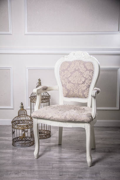 istock Old western style white elegant armchair with bird cage 1405141089