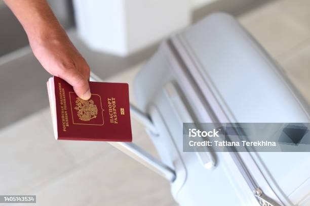 A Hand Holding Russian Passport And Suitcase Stock Photo - Download Image Now - Russia, Tourism, Russian Culture