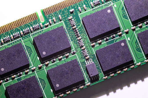 A macro photo of the small details of a computer ram chip on white background.