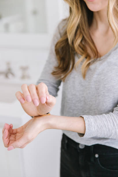 istock A women rubbing lotion onto her wrist 1405149328