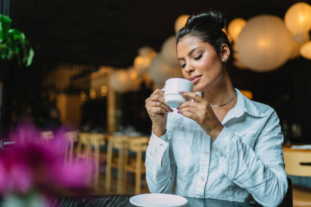 istock Latin woman in a cafe drinking coffee. 1405154527