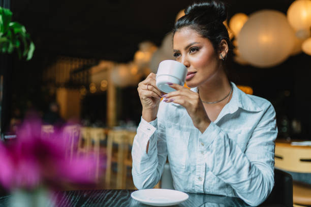 istock Latin woman in a cafe drinking coffee. 1405154530