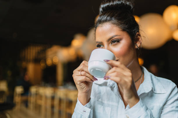 istock Latin woman in a cafe drinking coffee. 1405154564
