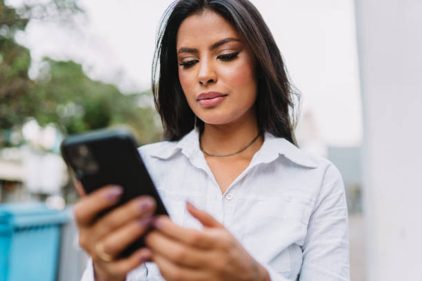 istock Beautiful Latin girl using her mobile phone. 1405154742