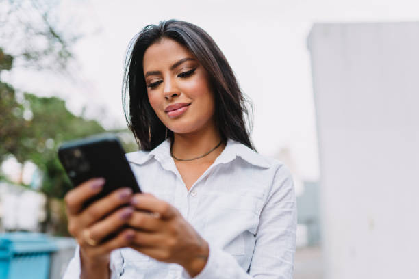 istock Beautiful Latin girl using her mobile phone. 1405154744
