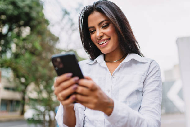 istock Beautiful Latin girl using her mobile phone. 1405154745