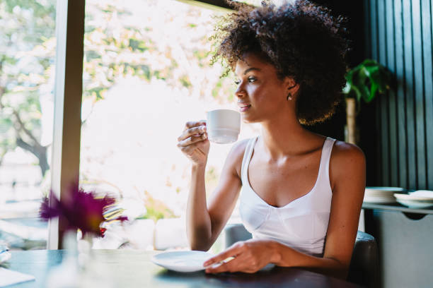 istock Latin woman in a cafe drinking coffee. 1405155023