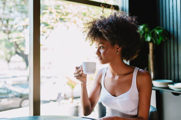 istock Latin woman in a cafe drinking coffee. 1405155032