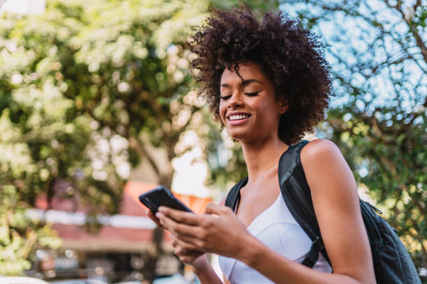 istock Beautiful Latin girl using her mobile phone. 1405155625
