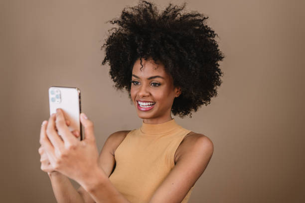 istock Beautiful Latin girl using her mobile phone. 1405157684