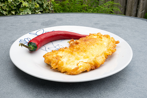 Red chili pepper and breaded aubergine (egg plant) on a plate: traditional hungarian food.
