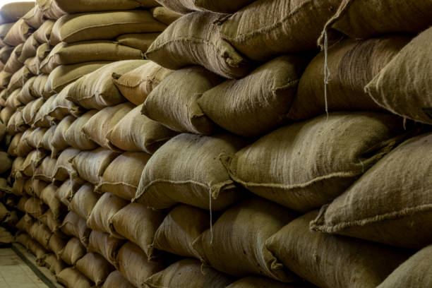 istock Stack Of Coffee Beans In Sacks At Warehouse - stock photo 1405166450