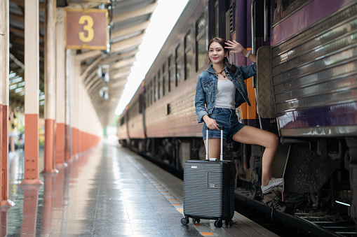 Asian woman going to travel by a train