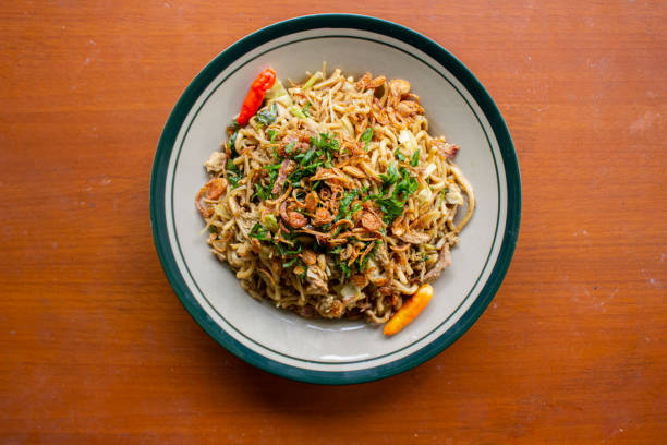 Mie Goreng Jawa or bakmi jawa or java noodle with
spoon and fork. Indonesian traditional street food noodles from central java or Yogyakarta, indonesia