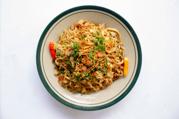 istock Mie Goreng Jawa or bakmi jawa or java noodle withspoon and fork. Indonesian traditional street food noodles from central java or Yogyakarta, indonesia 1405170340