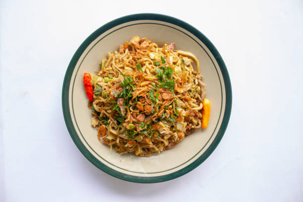 istock Mie Goreng Jawa or bakmi jawa or java noodle withspoon and fork. Indonesian traditional street food noodles from central java or Yogyakarta, indonesia 1405170358