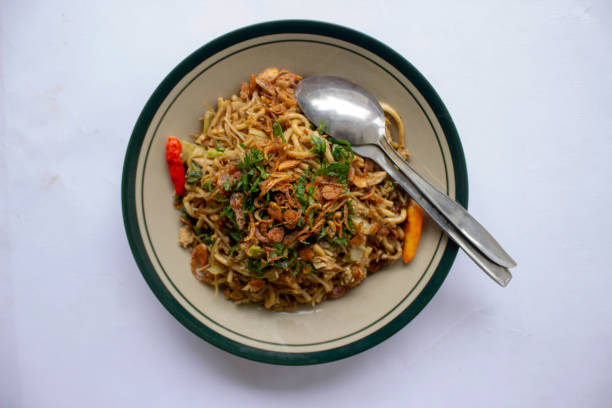 istock Mie Goreng Jawa or bakmi jawa or java noodle withspoon and fork. Indonesian traditional street food noodles from central java or Yogyakarta, indonesia 1405170406