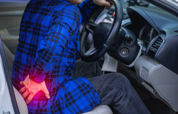 istock The young man had a backache even driving long distances, focusing on the red dot. 1405171182