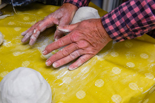 istock Female hands making ceramic art and pottery in a workshop class for mature people 1405176556