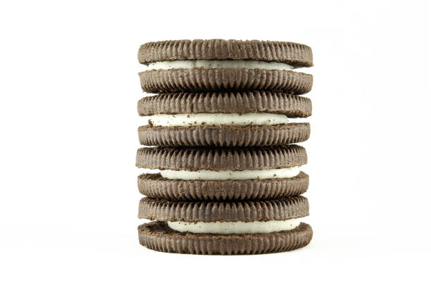Stack of vanilla milky cream filled sandwich cookies isolated on white background