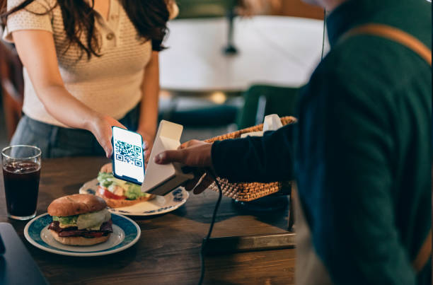 istock Customer using contactless payment in a coffee shop 1405177497