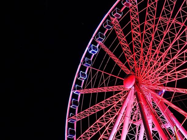 istock Low Angle View Of Illuminated Ferris Wheel Against Sky At Night 1405178217