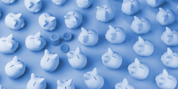 istock Many piggy banks looking at coins. Copy space. 3D illustration. 1405179828