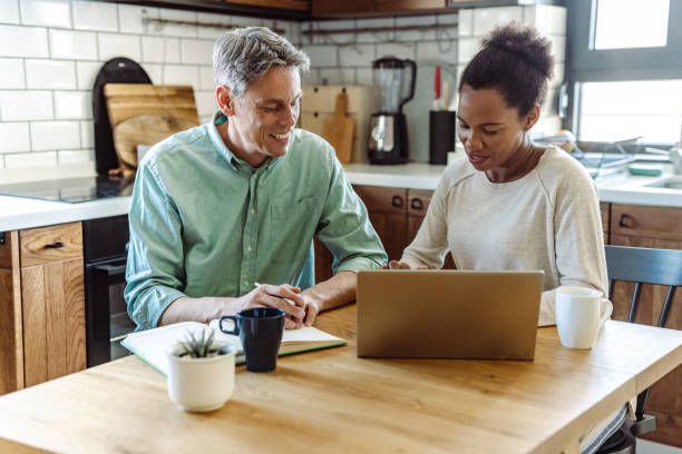 istock Multi-racial mature couple calculating home budget 1405181417