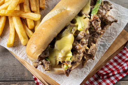 Philly cheese steak sandwich on wooden table