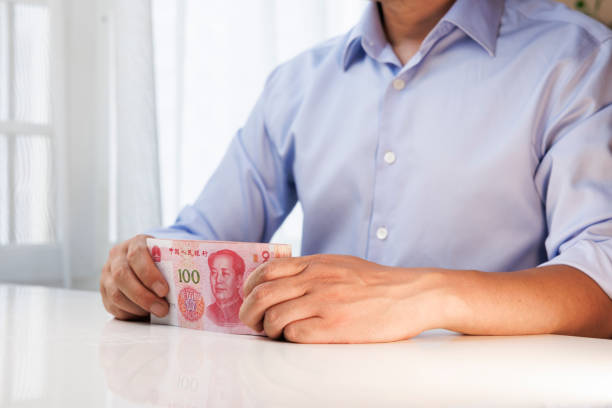istock The man is holding RMB bills in his hands 1405182166