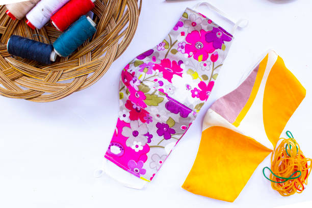 istock cloth mask or fabric face mask with cotton fabric flower pattern handmade crafts isolated on white background. This hygienic mask for cover mouth and protection with beautiful sewing fashion. 1405182862