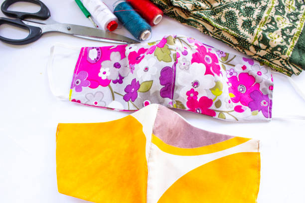 istock cloth mask or fabric face mask with cotton fabric flower pattern handmade crafts isolated on white background. This hygienic mask for cover mouth and protection with beautiful sewing fashion. 1405182873