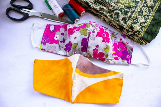 istock cloth mask or fabric face mask with cotton fabric flower pattern handmade crafts isolated on white background. This hygienic mask for cover mouth and protection with beautiful sewing fashion. 1405182877