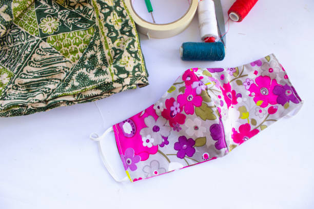 istock cloth mask or fabric face mask with cotton fabric flower pattern handmade crafts isolated on white background. This hygienic mask for cover mouth and protection with beautiful sewing fashion. 1405182891
