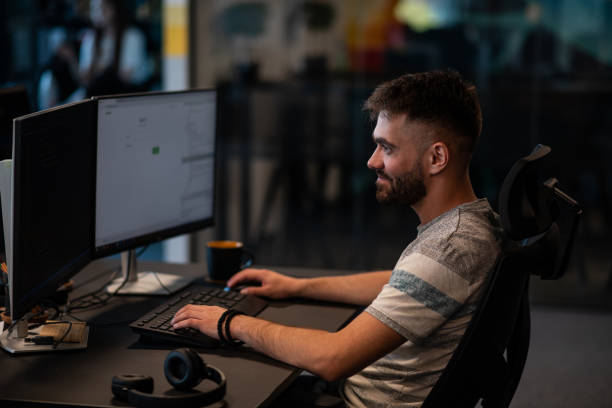 istock Young man sitting at his desk in a joint office 1405184156